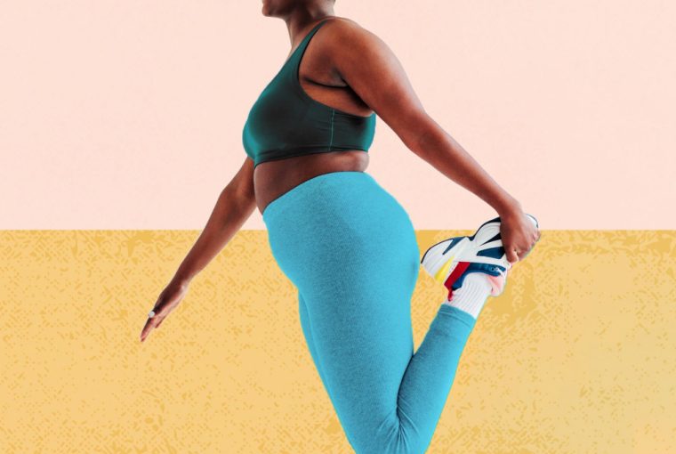 a woman stretching her legs as she prepares for a workout