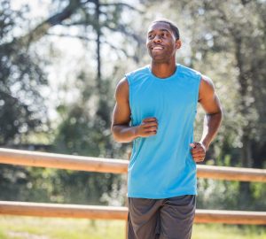 a man in a tank top running outside