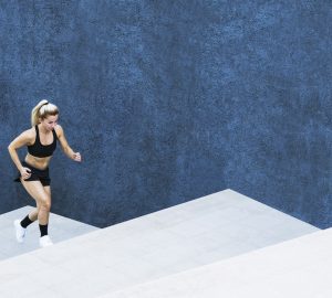 a woman sunning up some stairs against a dark blue background