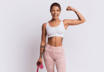 a fit woman flexing her bicep