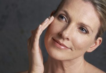 a beautiful woman touching her face