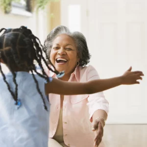 a grandmother getting ready to hug their grandchild