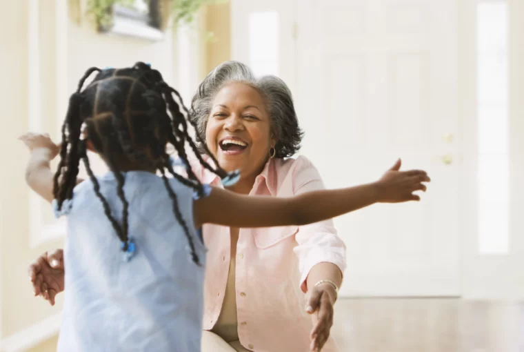 a grandmother getting ready to hug their grandchild