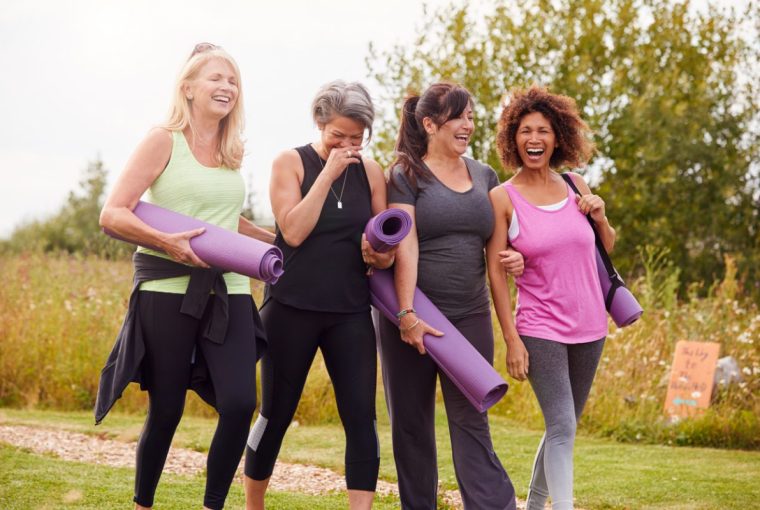 a group of women walking outdoors laughing