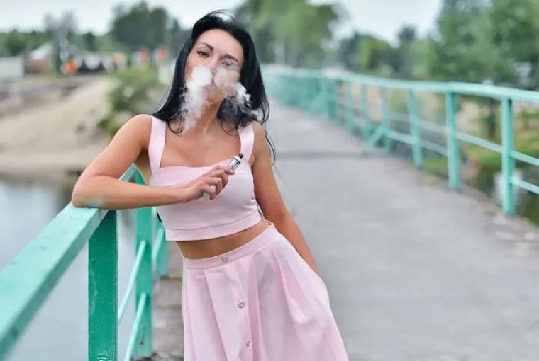 a woman using a vape