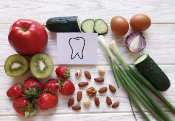 an assortment of healthy foods and an image of a tooth