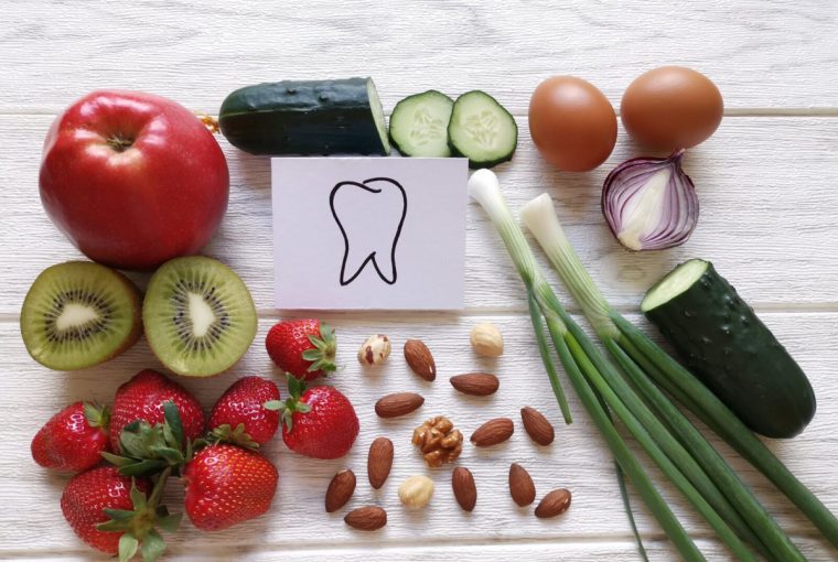 an assortment of healthy foods and an image of a tooth