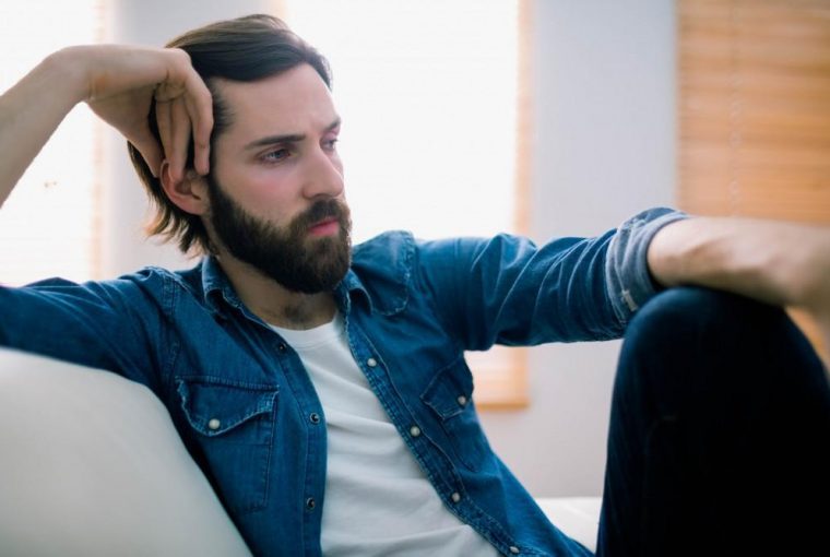 a man sitting on a chair in deep thought