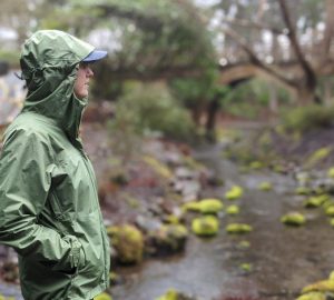 a person exploring the outdoors wearing a rain coat