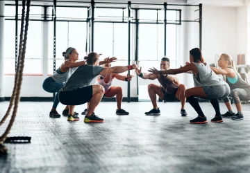 a group of people doing a workout inside