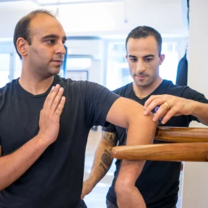 a man doing martial arts with a teacher