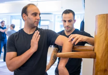 a man doing martial arts with a teacher