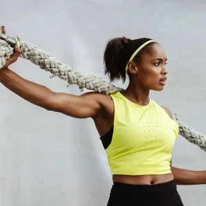 a woman stretching with a battle rope