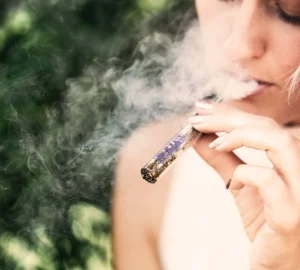 a woman using a vape pen