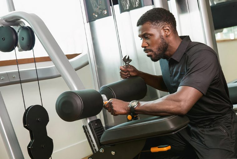 a man repairing fitness equipment