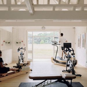 A home gym space with a couple working out in it