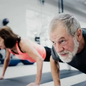 a pair of seniors doing pushups