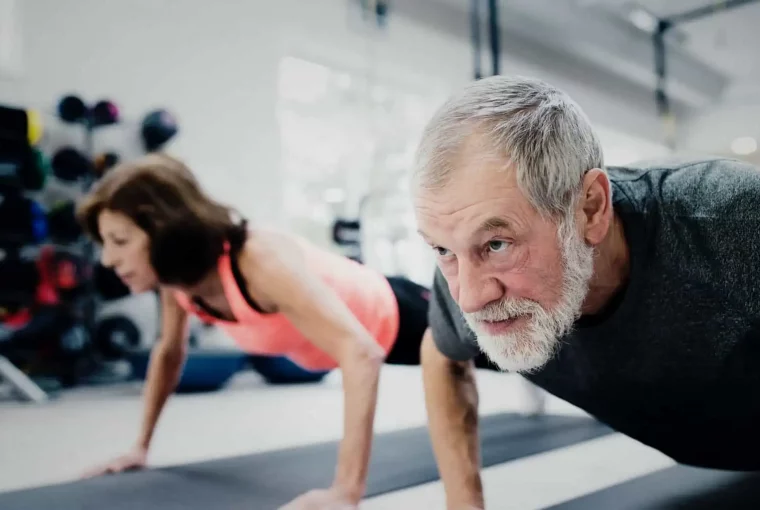 a pair of seniors doing pushups