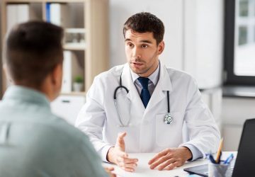 a man sitting down with his doctor