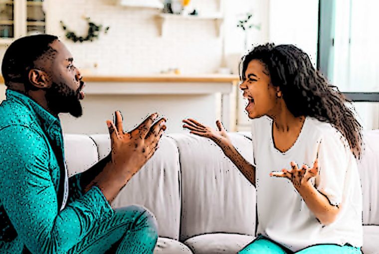 a couple yelling at each other gesturing on the sofa