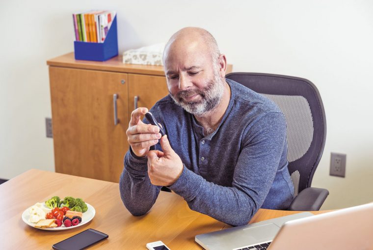 a man testing his blood for blood sugar