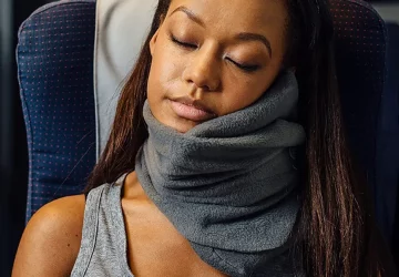 a woman using a travel pillow