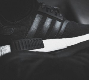 a black and white photo of a running shoe