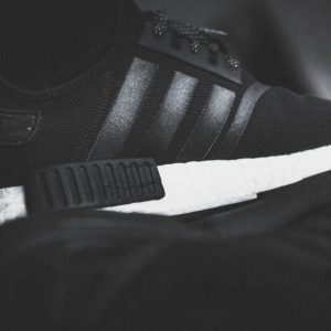 a black and white photo of a running shoe