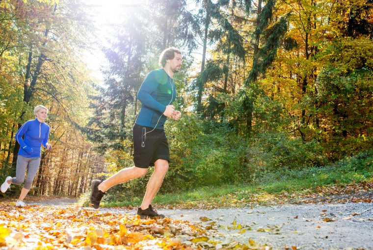 a couple running outdoors