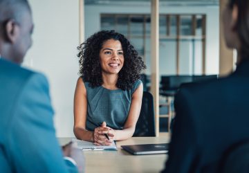 a smiling woman talking to clients