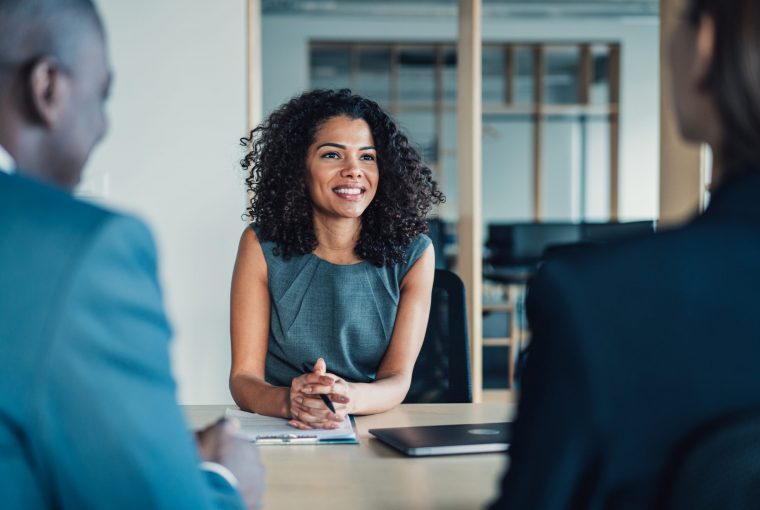 a smiling woman talking to clients