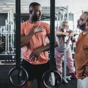 a trainer talking to a client in the gym