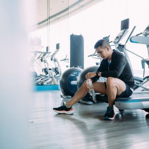 a man at the gym checking his smart watch