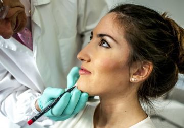 a woman with a doctor preparing for jaw surgery