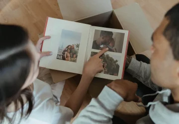 a parent and child looking at a photo album