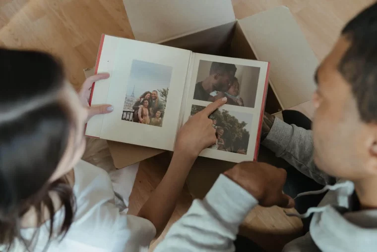 a parent and child looking at a photo album