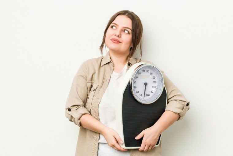 a woman holding a scale
