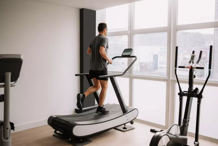 a man running using a manual treadmill