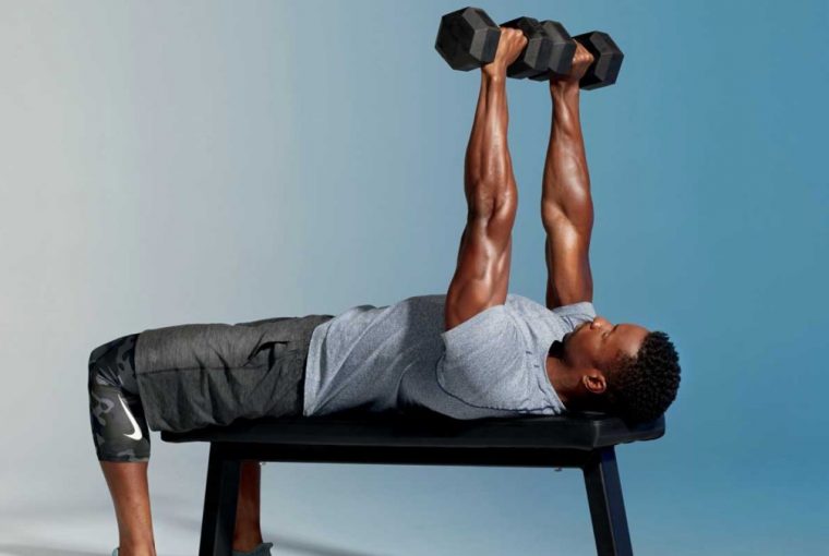a man doing chest press with dumbbells