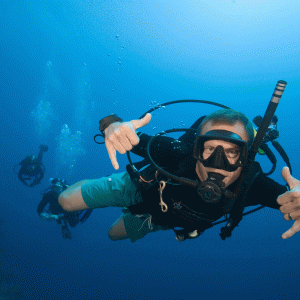 an underwater dive master looking at the camera