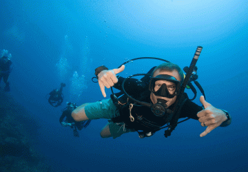 an underwater dive master looking at the camera