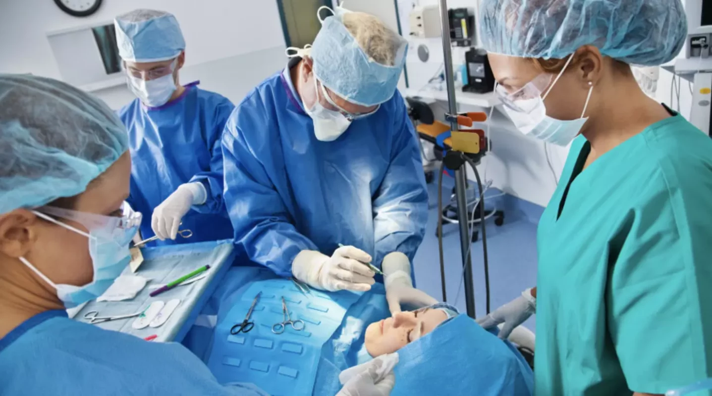 a group of surgeons working on a patient