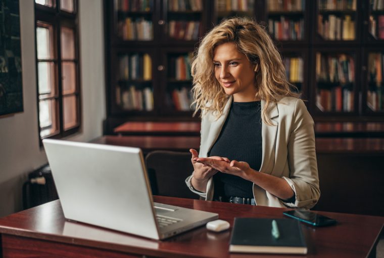 a woman at a computer in a library