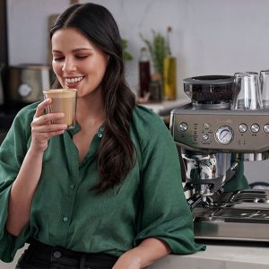 a woman enjoying a coffee beverage