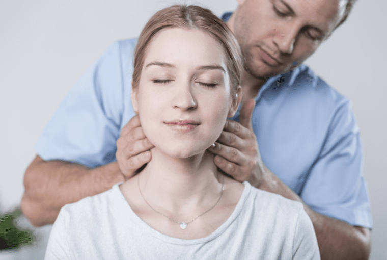 a woman receiving a neck adjustment