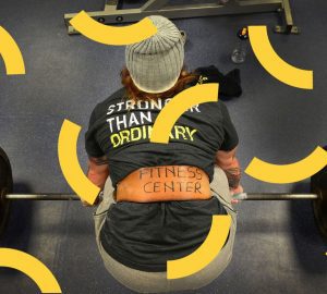 a woman with a weight belt on bent over