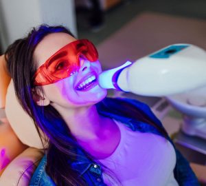 a woman receiving a teeth whitening service