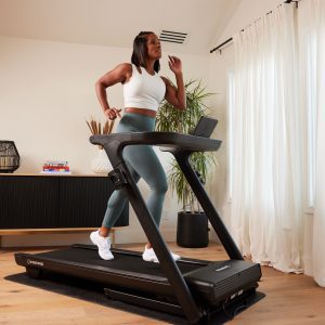 a woman running on a treadmill