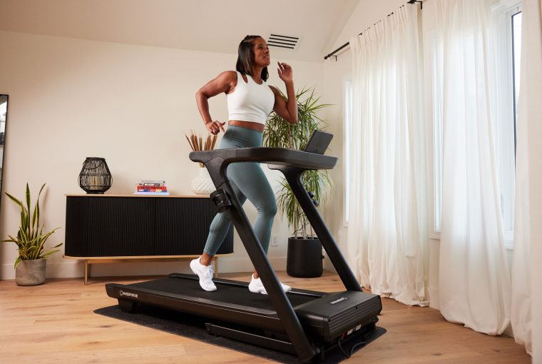 a woman running on a treadmill
