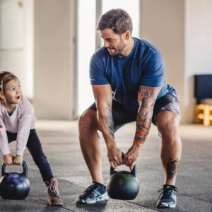 a father and daughter working out
